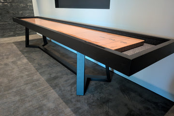 Shuffleboard table in a room with a television mounted on the wall.