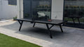 Modern outdoor patio with ping pong table, chairs, and garden view