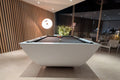 Modern pool table in a stylish room with wooden walls and a light floor.