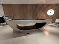 Modern pool table in a stylish room with wooden paneling and chairs.