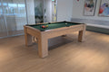 Pool table in a room with large windows and modern decor